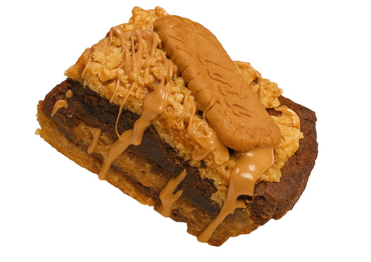 Close-up of a layered dessert with chocolate, caramel, and cookie pieces on a white background